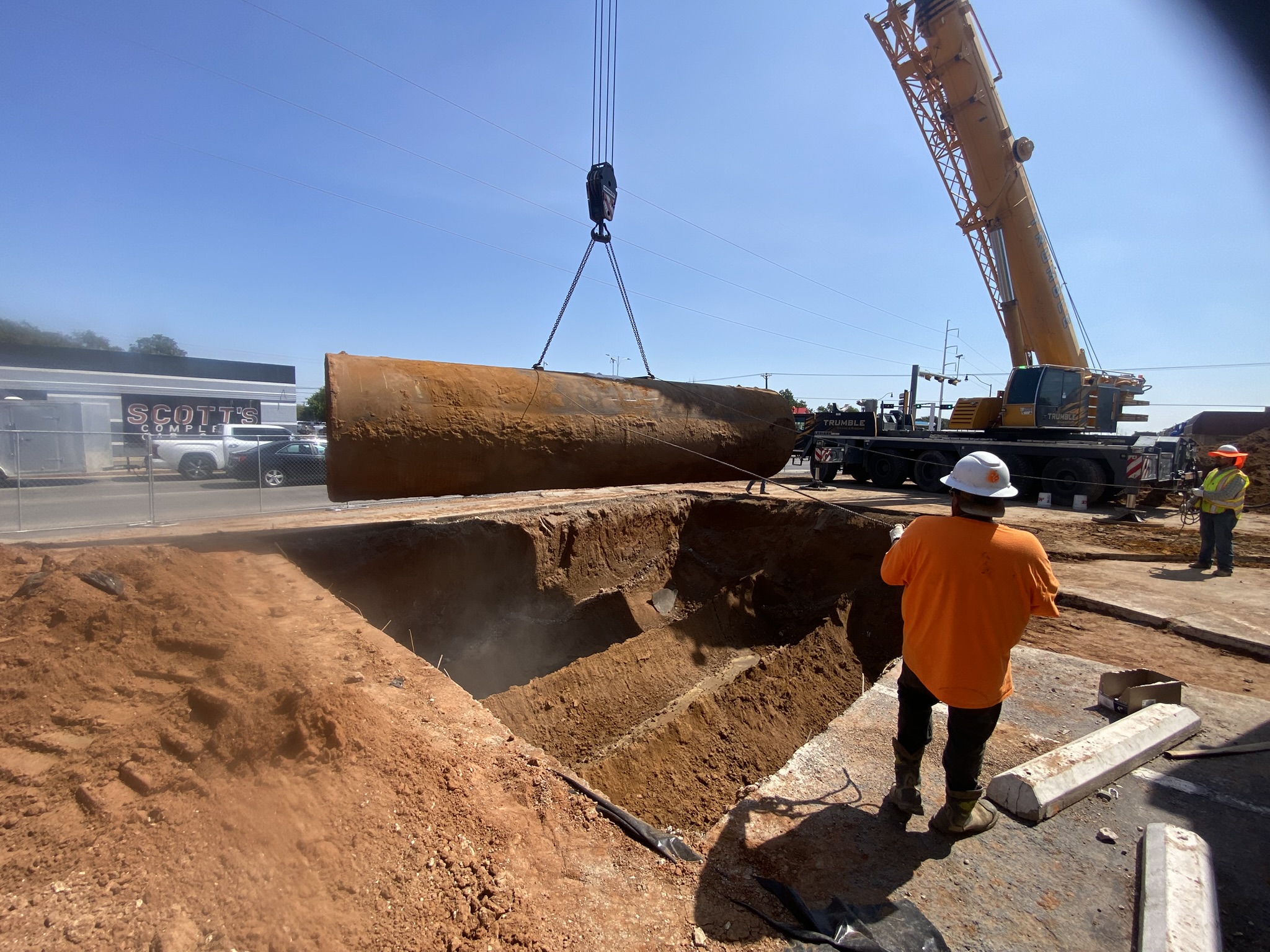 Crane lifting an underground storage tank during removal