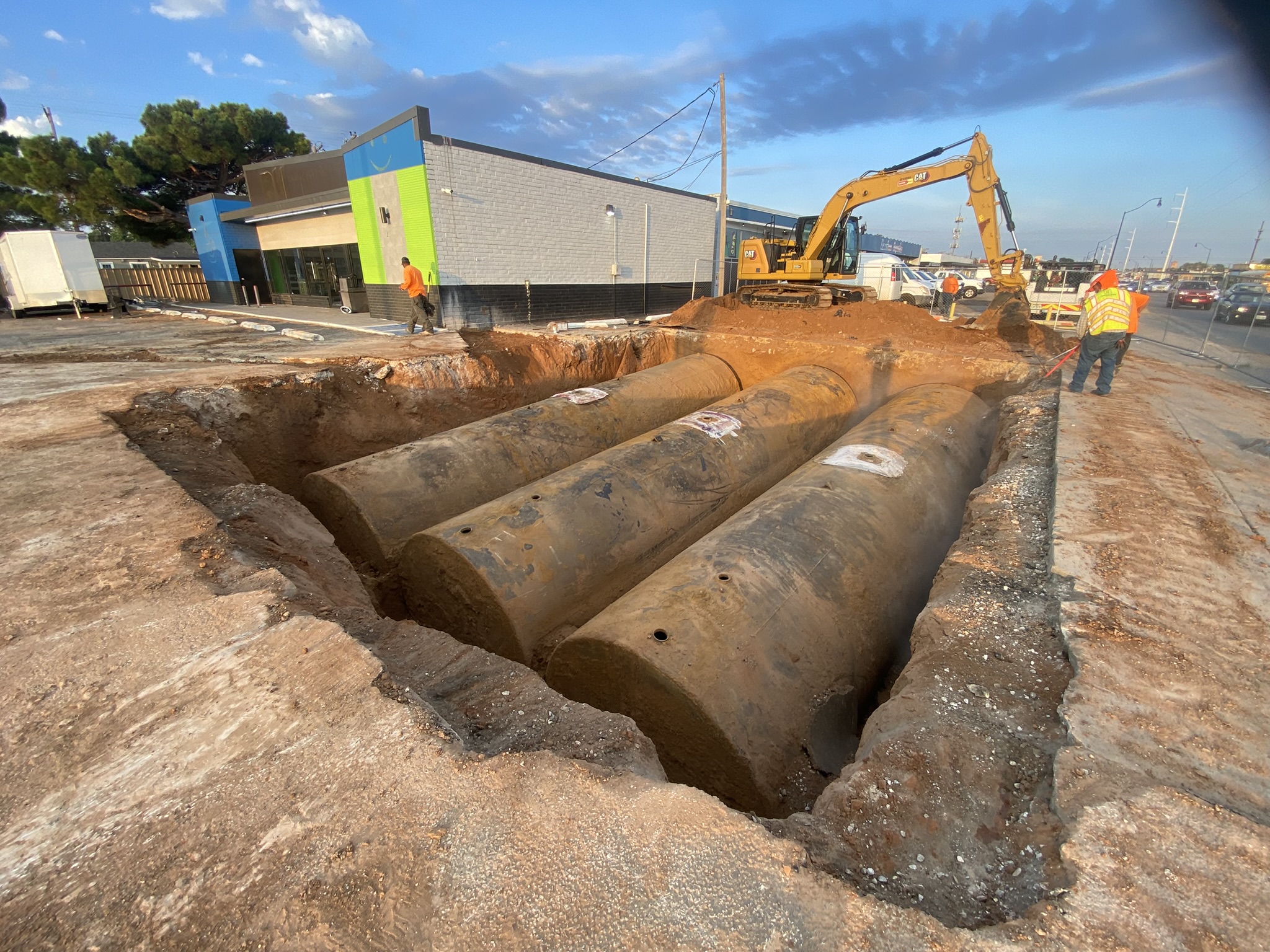 Three underground storage tanks exposed in excavation pit